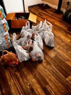 Bags of packed food and drinks ready for distribution